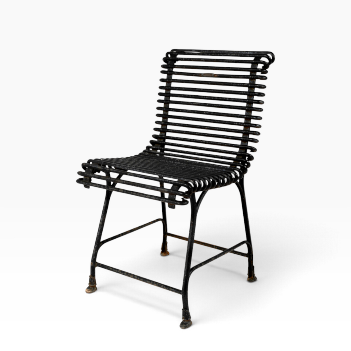The Well by BDAntiques sculptural black metal outdoor chair with a curved iron rod frame and industrial design.