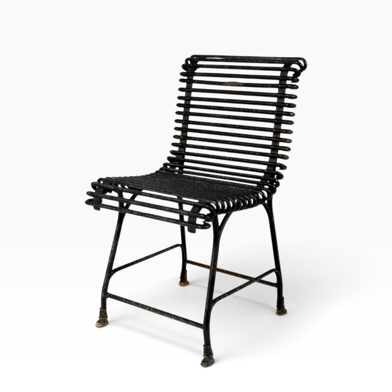 The Well by BDAntiques sculptural black metal outdoor chair with a curved iron rod frame and industrial design.