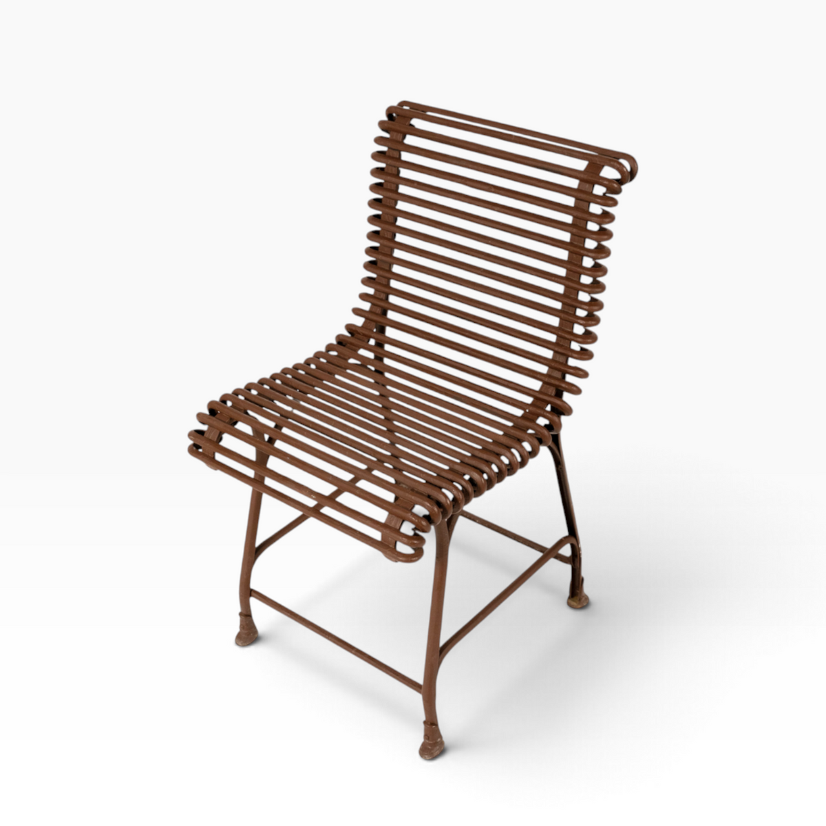 The Well by BDAntiques rust-colored metal outdoor chair with a sculptural, open-frame design made of curved iron rods.