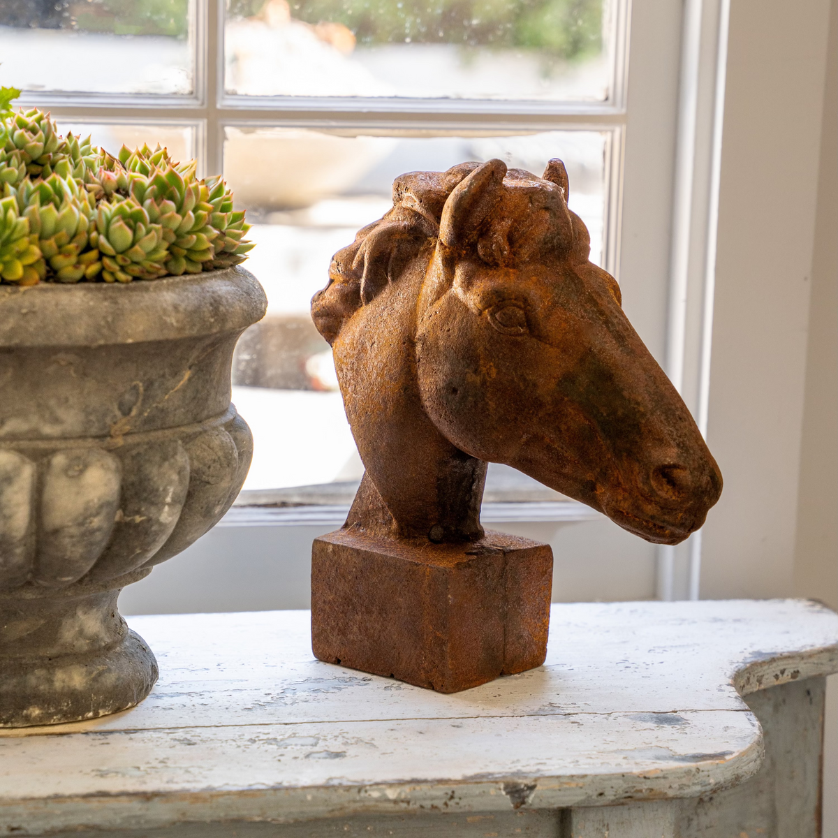 The Well by BDAntiques rustic horse head sculpture with a weathered, rusted finish displayed on a white mantel.