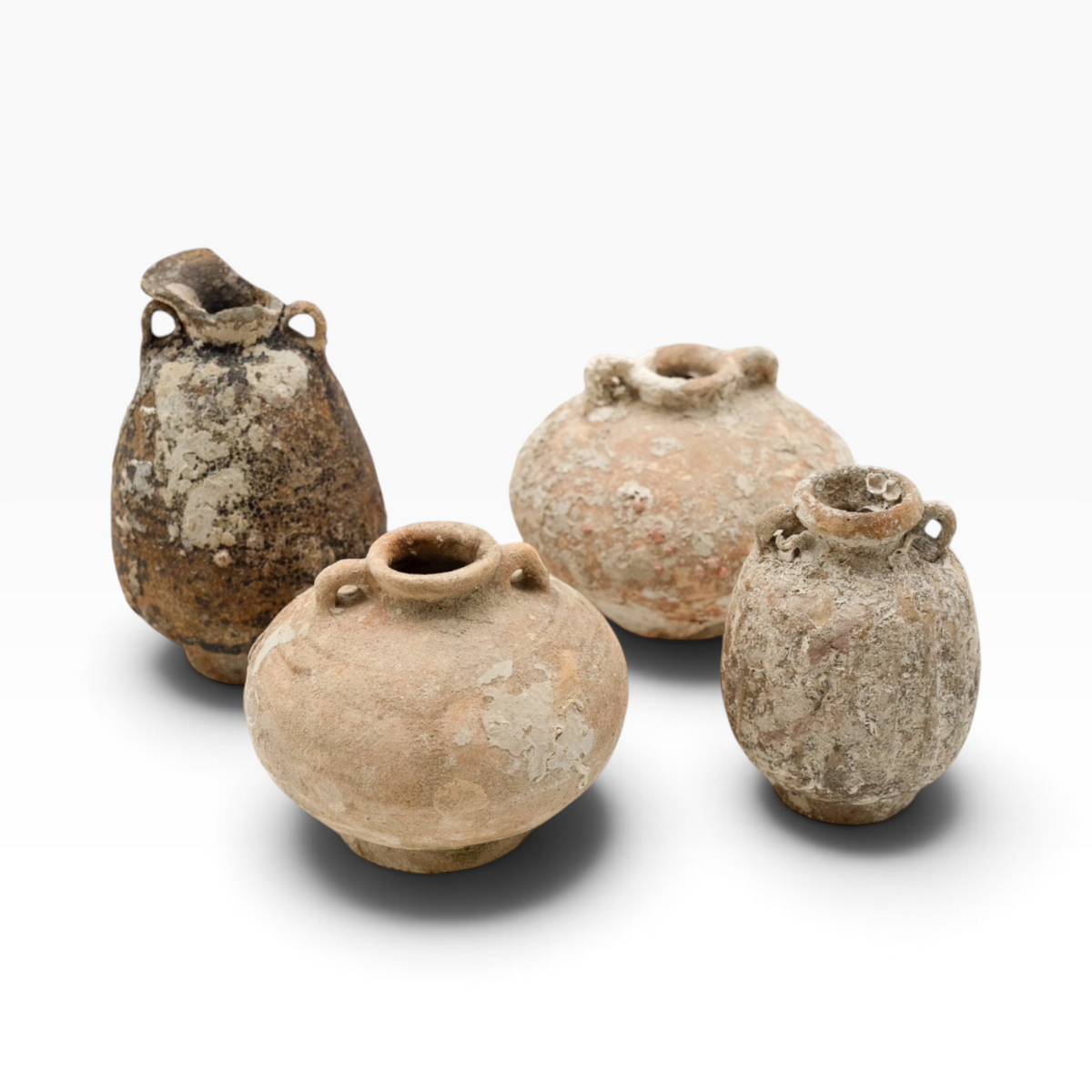 The Well by BDAntiques collection of four antique shipwreck pottery vases with weathered, encrusted textures.