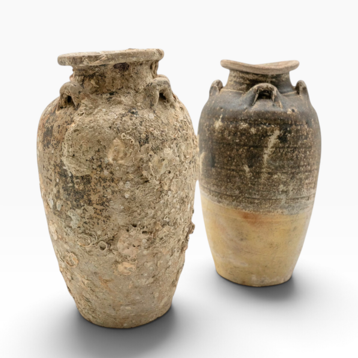 Two antique Shipwreck Pottery vases from The Well by BDAntiques featuring weathered textures and marine encrustations.