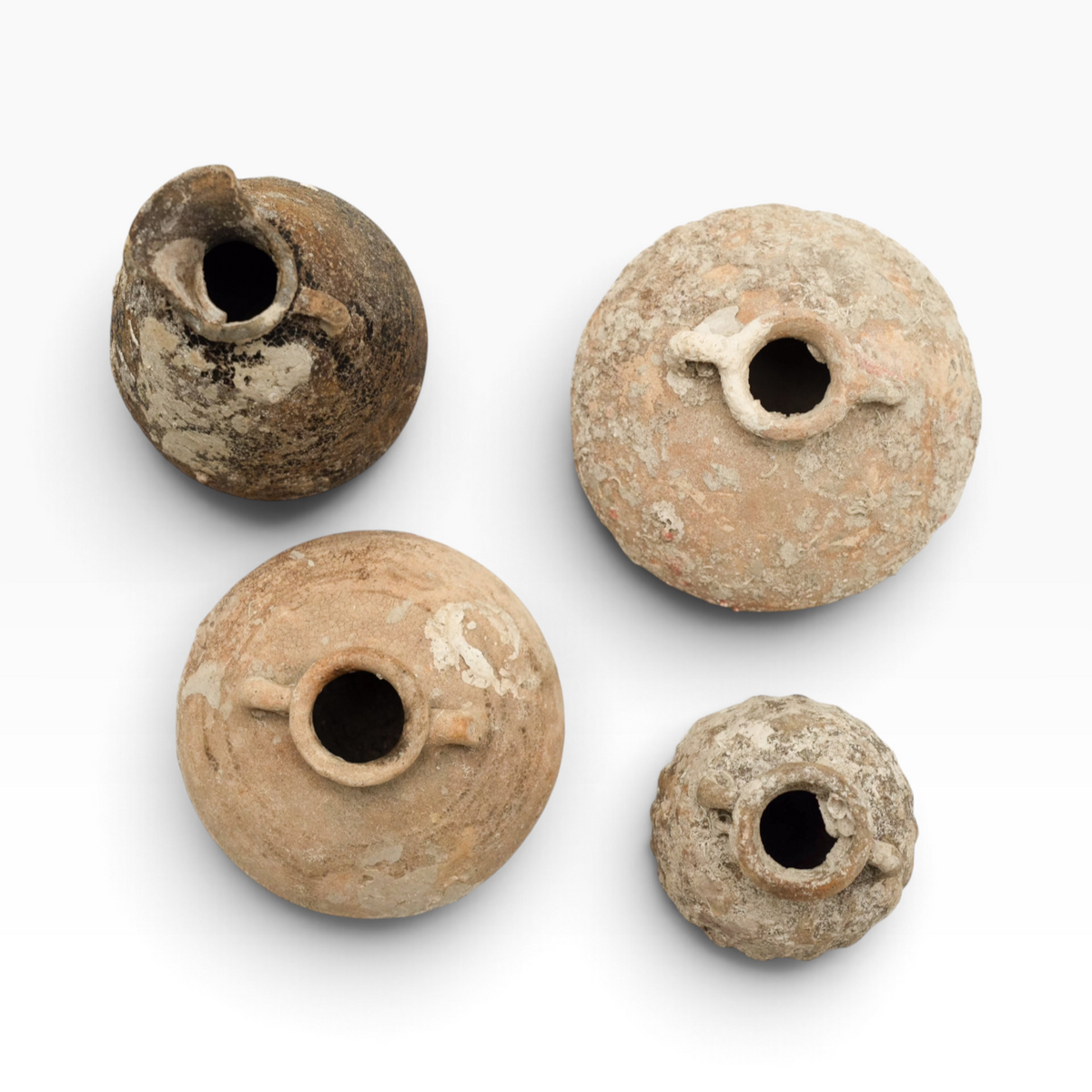 The Well by BDAntiques collection of four antique shipwreck pottery vases with weathered textures and encrustations.