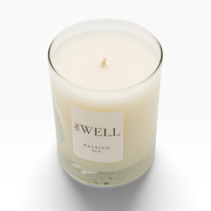 The Well by BDAntiques No. 8 soy wax candle in a clear blown glass vessel with a minimalist label