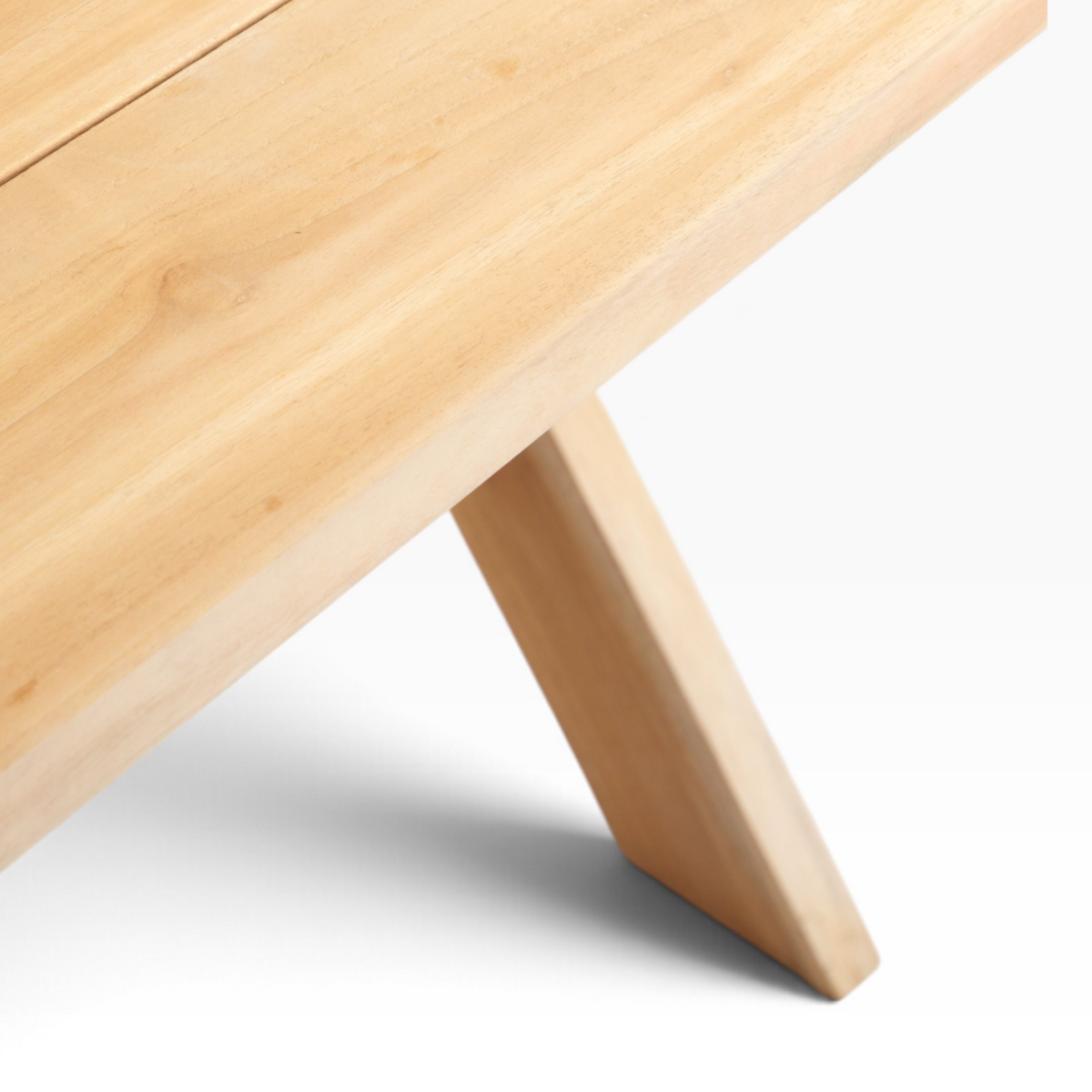 The Well by BDAntiques custom teak outdoor dining table featuring a light wood grain and sturdy trestle base design.