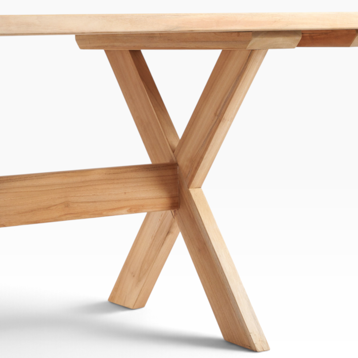 The Well by BDAntiques custom teak outdoor dining table featuring a sturdy trestle base and natural wood grain finish.