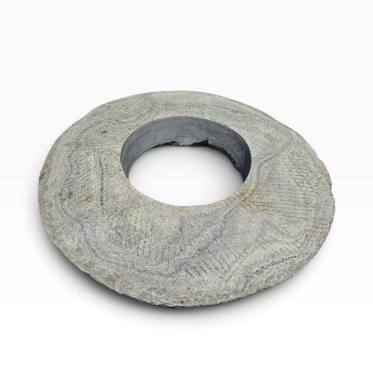 The Well by BDAntiques vintage millstone fire pit with a weathered grey stone texture and a central circular opening.
