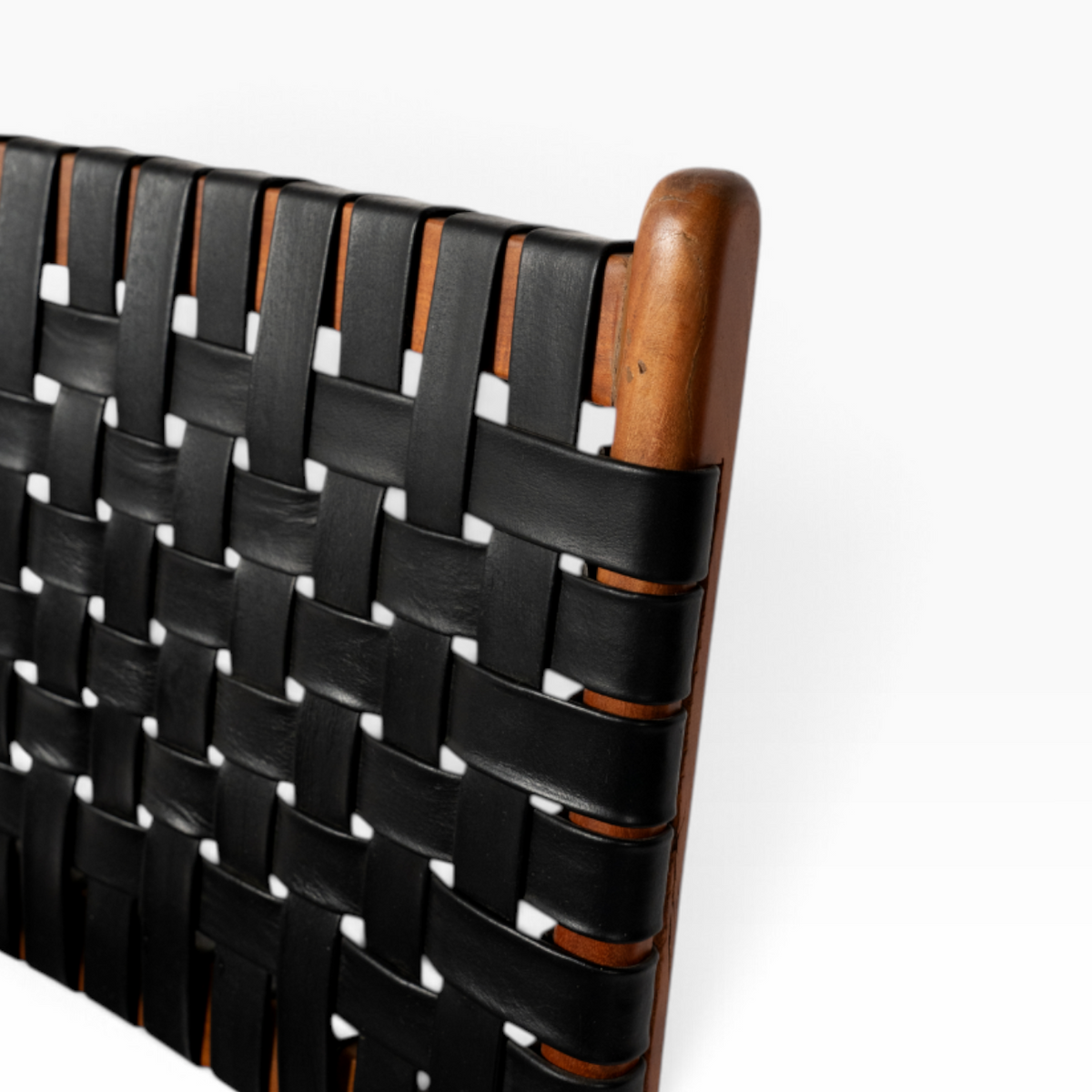 The Well by BDAntiques wooden dining chair featuring a black handwoven leather seat and backrest with a wood frame.